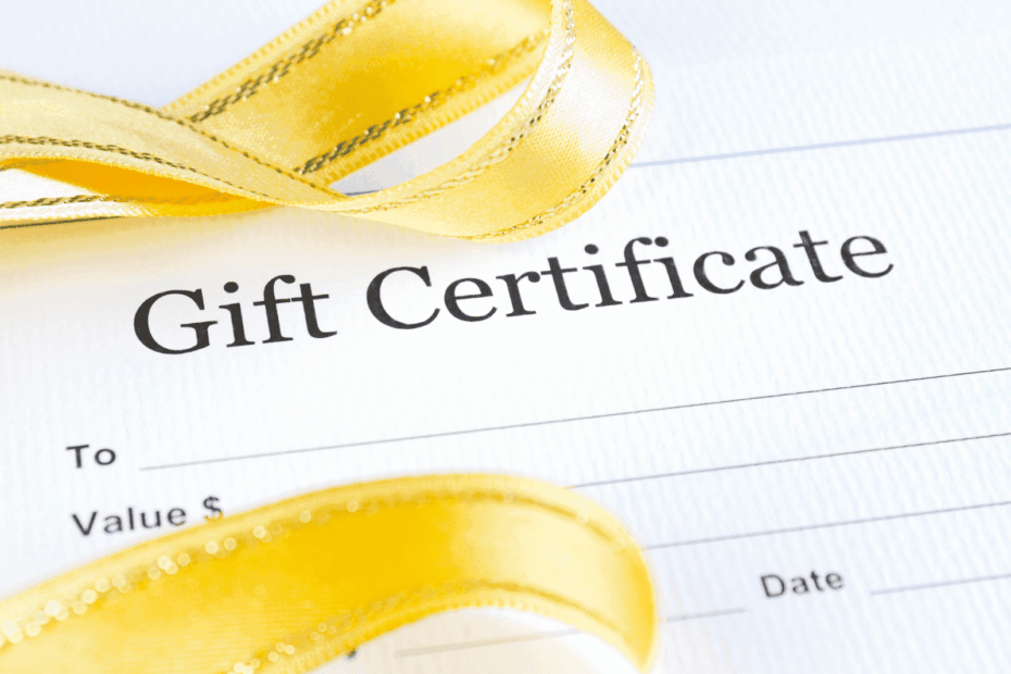 Close-up of a gift certificate with a yellow ribbon across the paper