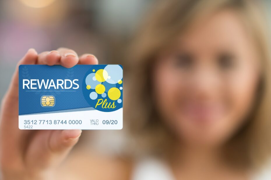 Woman holding a rewards card close to the camera