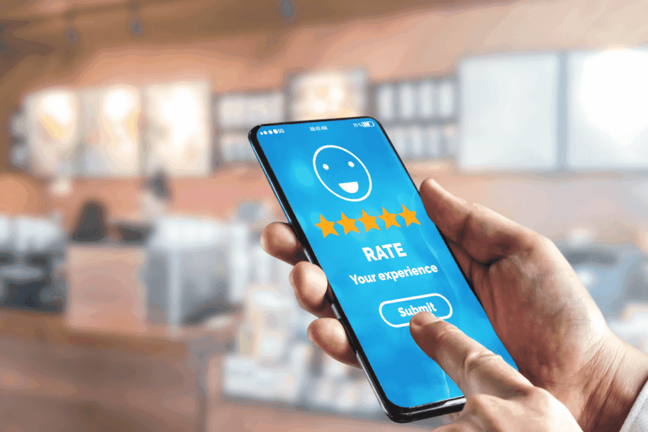 Person using a smartphone to submit a five-star rating for a customer experience