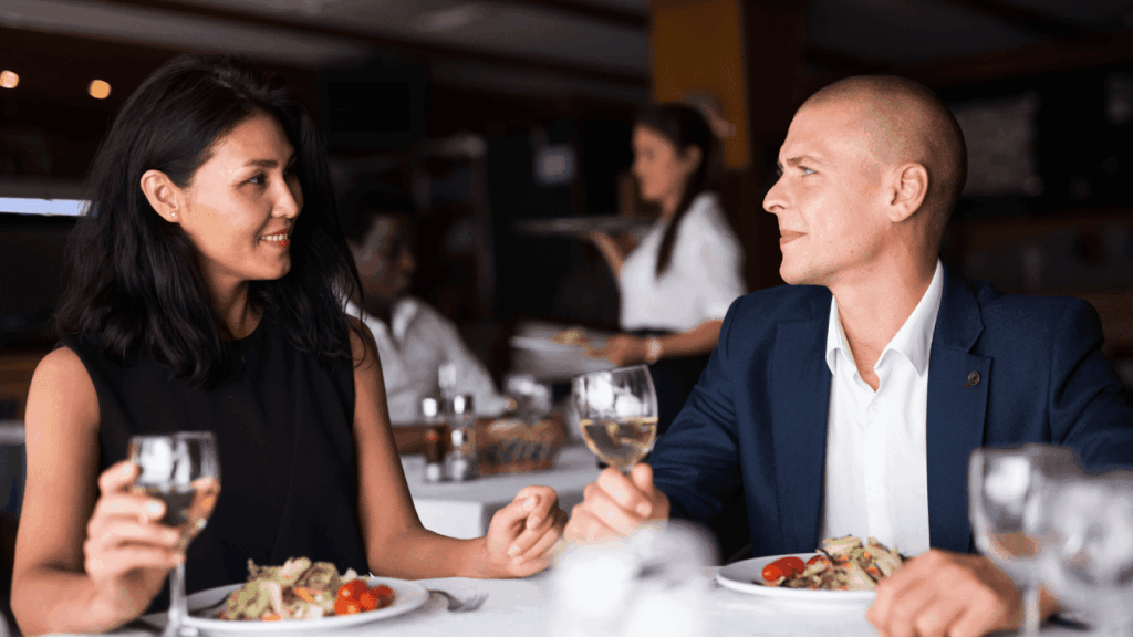 A Man and a woman having a meal and talking in a restaurant