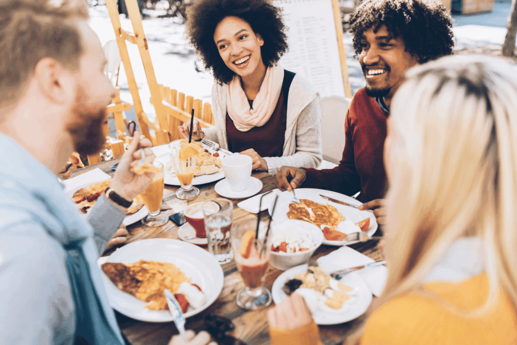 A group of friends enjoying brunch together at an outdoor restaurant.