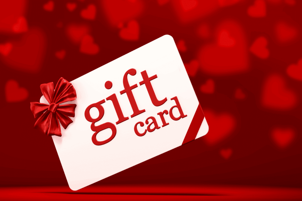 A red and white gift card with a bow on a red heart-themed background.