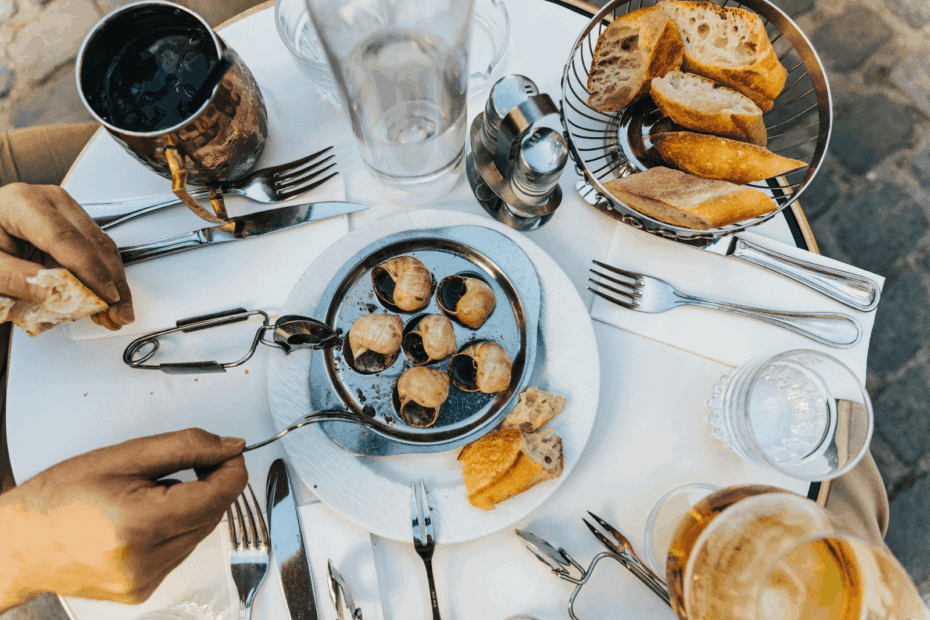 Assorted appetizers and plated dishes arranged on a wooden table.